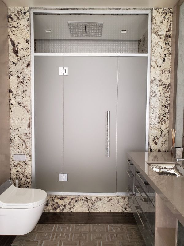 A bathroom with a toilet , sink , and shower.