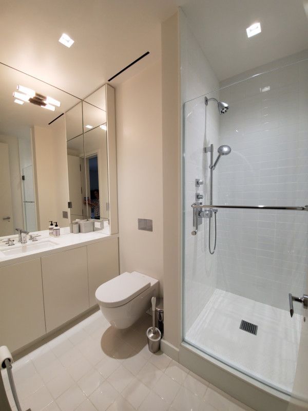 A bathroom with a toilet a sink and a shower