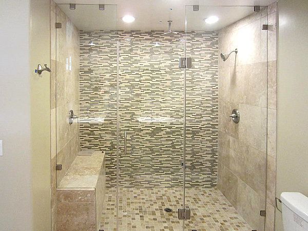 A bathroom with a walk in shower and a toilet.