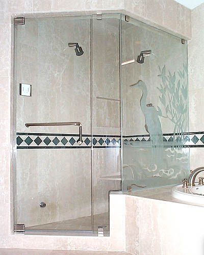 A bathroom with a glass shower door and a sink