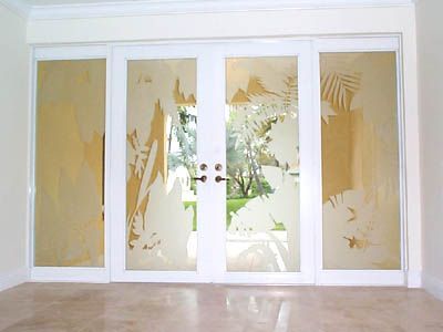 A sliding glass door with a tropical design on it