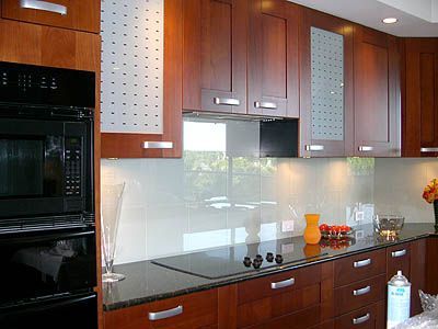 A kitchen with wooden cabinets and a black stove top oven