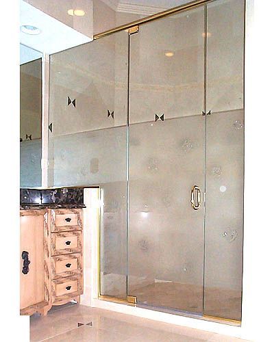 A bathroom with a sliding glass shower door