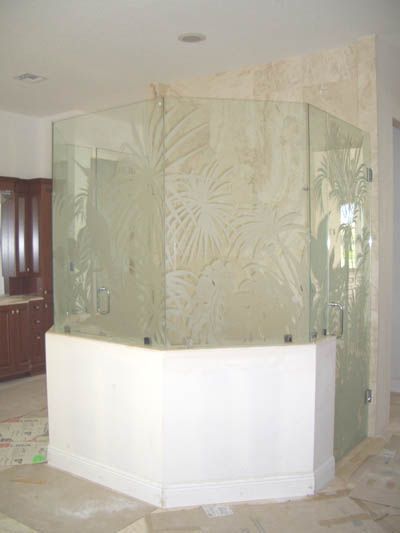 A bathroom with a bathtub and a glass shower door.