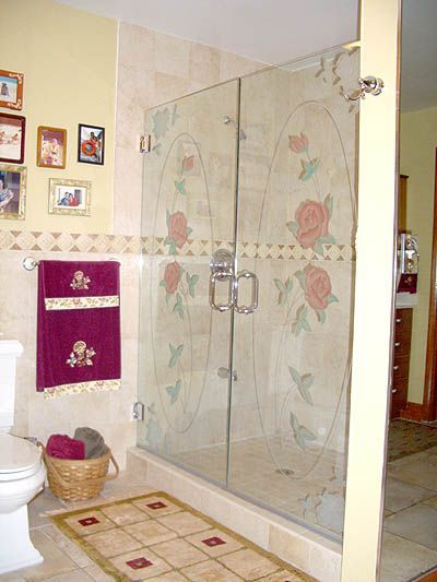 A bathroom with a walk in shower and a toilet.