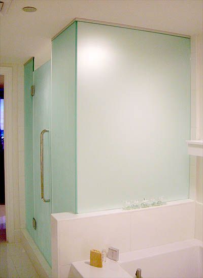 A bathroom with a bathtub and a glass shower door
