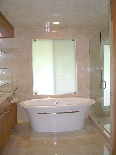 A bathroom with a bathtub and a window