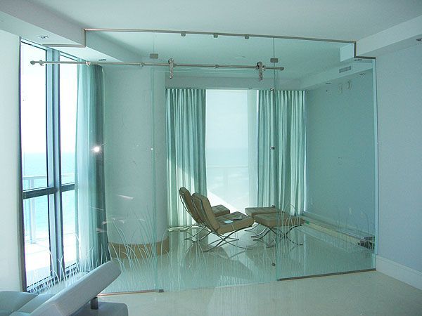 A living room with a chair and ottoman in front of a large window