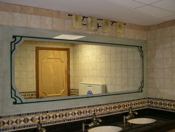 A bathroom with two sinks and a large mirror