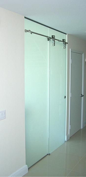 A hallway with sliding glass doors and white doors