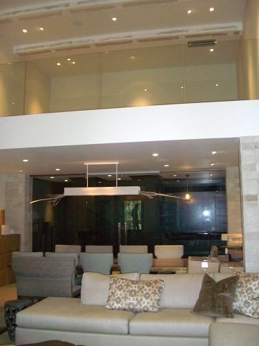 A living room with a couch and a glass railing