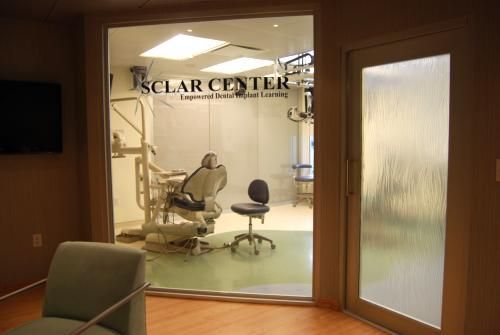 A view of a dental office through a glass door