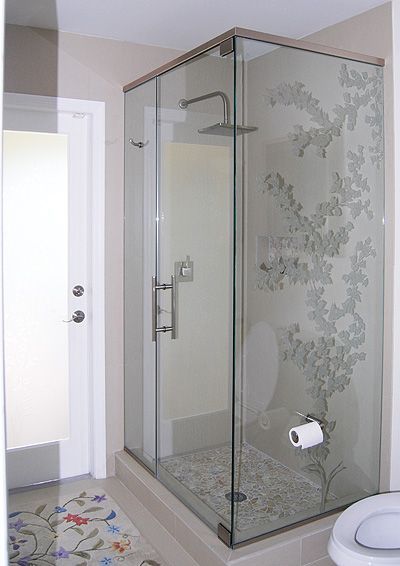 A bathroom with a walk in shower and a toilet