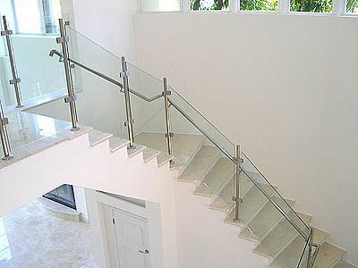 A staircase with a glass railing in a house.
