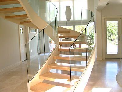 A spiral staircase with a glass railing in a house
