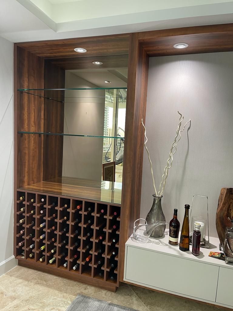 There is a wine rack in the middle of the room.