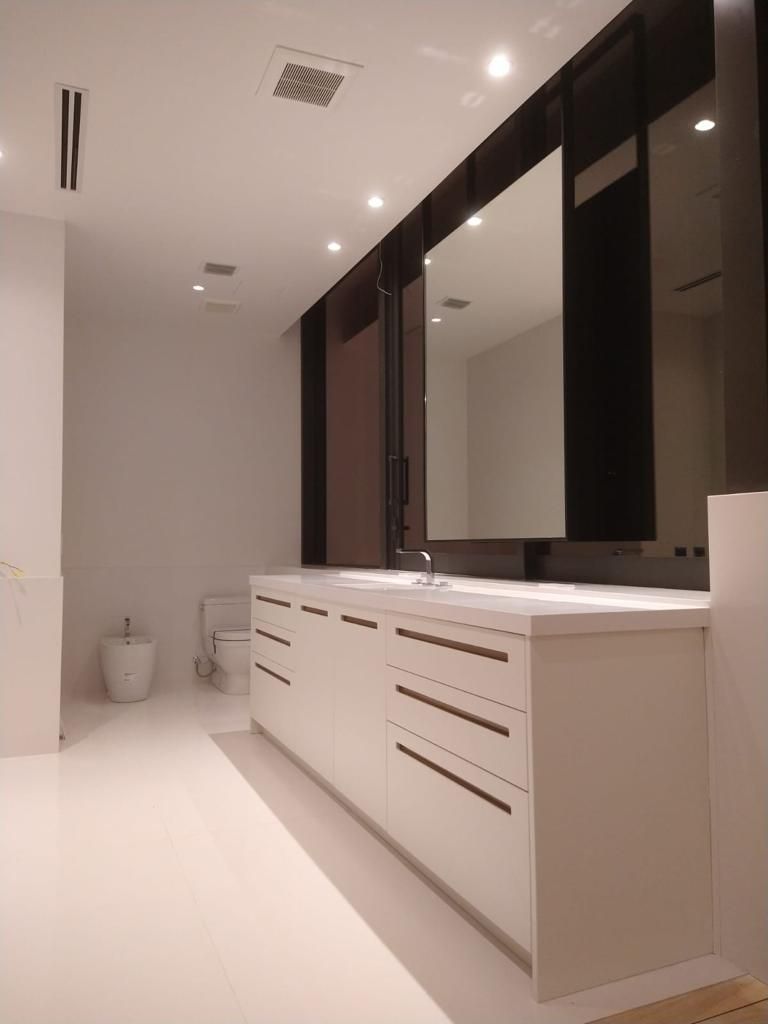 A bathroom with two sinks and two mirrors.