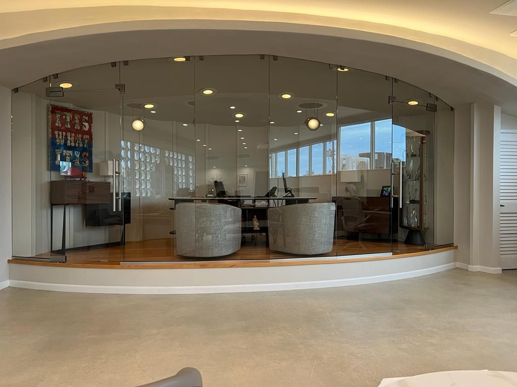 A room with a lot of windows and a glass wall.