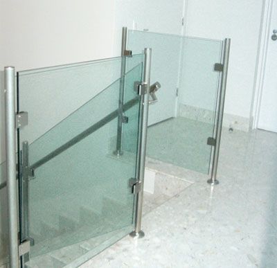 A staircase with a glass railing and a marble floor