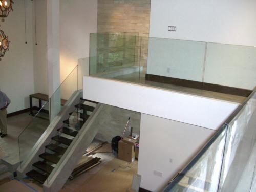 A staircase with a glass railing in a house