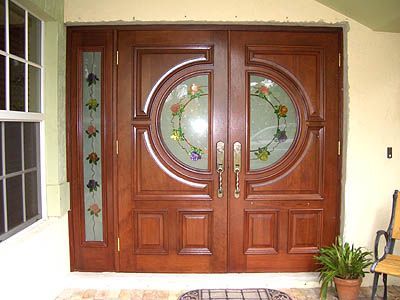 A pair of wooden doors with stained glass windows