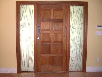 A wooden door with stained glass in a room