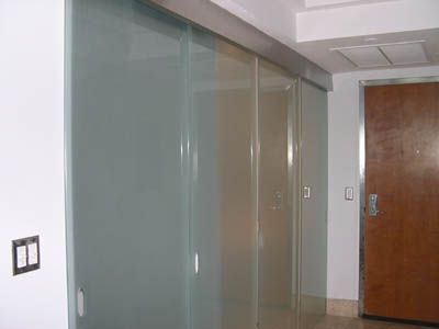 A hallway with sliding glass doors and a wooden door.