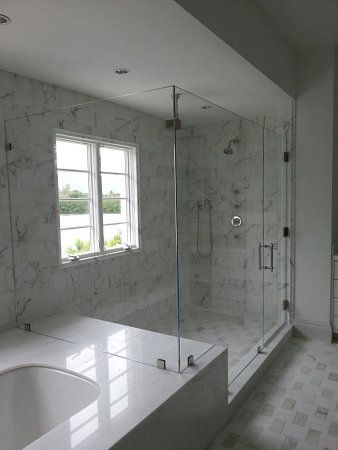 A bathroom with a tub , shower , and window.