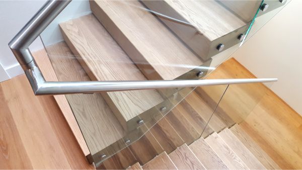 A staircase with wooden steps and a glass railing