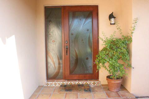 There is a potted plant in front of the door.