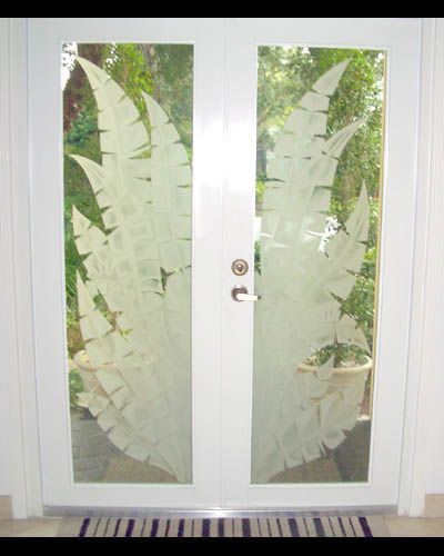 A white door with a leaf design on it