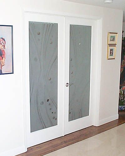 A hallway with a picture on the wall above the doors