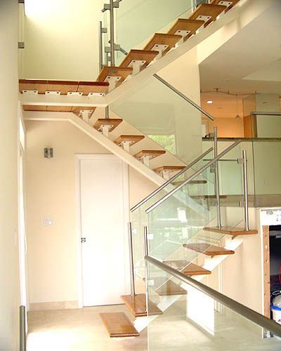 A staircase with wooden steps and a glass railing