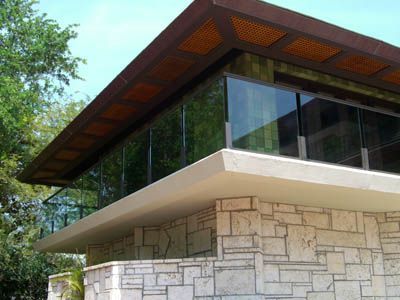 A house with a lot of windows and a wooden roof
