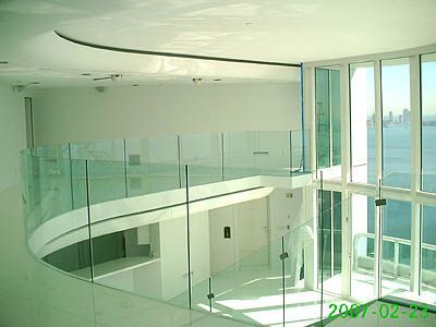 A large room with lots of windows and a glass railing