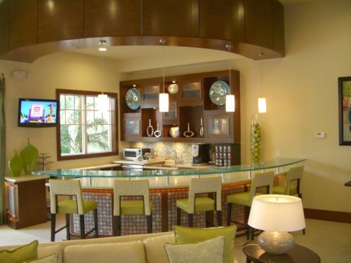 A living room with a bar and a flat screen tv