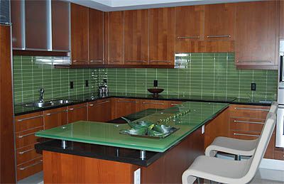 A kitchen with wooden cabinets and a green counter top