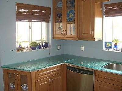 A kitchen with wooden cabinets and a stainless steel dishwasher