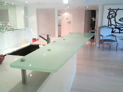 A kitchen with a large glass counter top