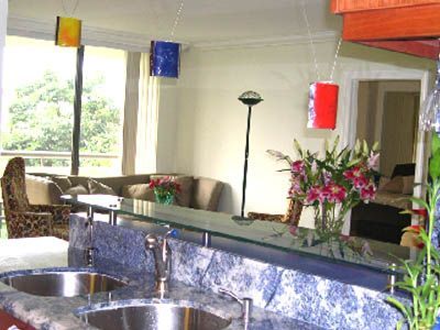 A kitchen with two sinks and a glass counter top