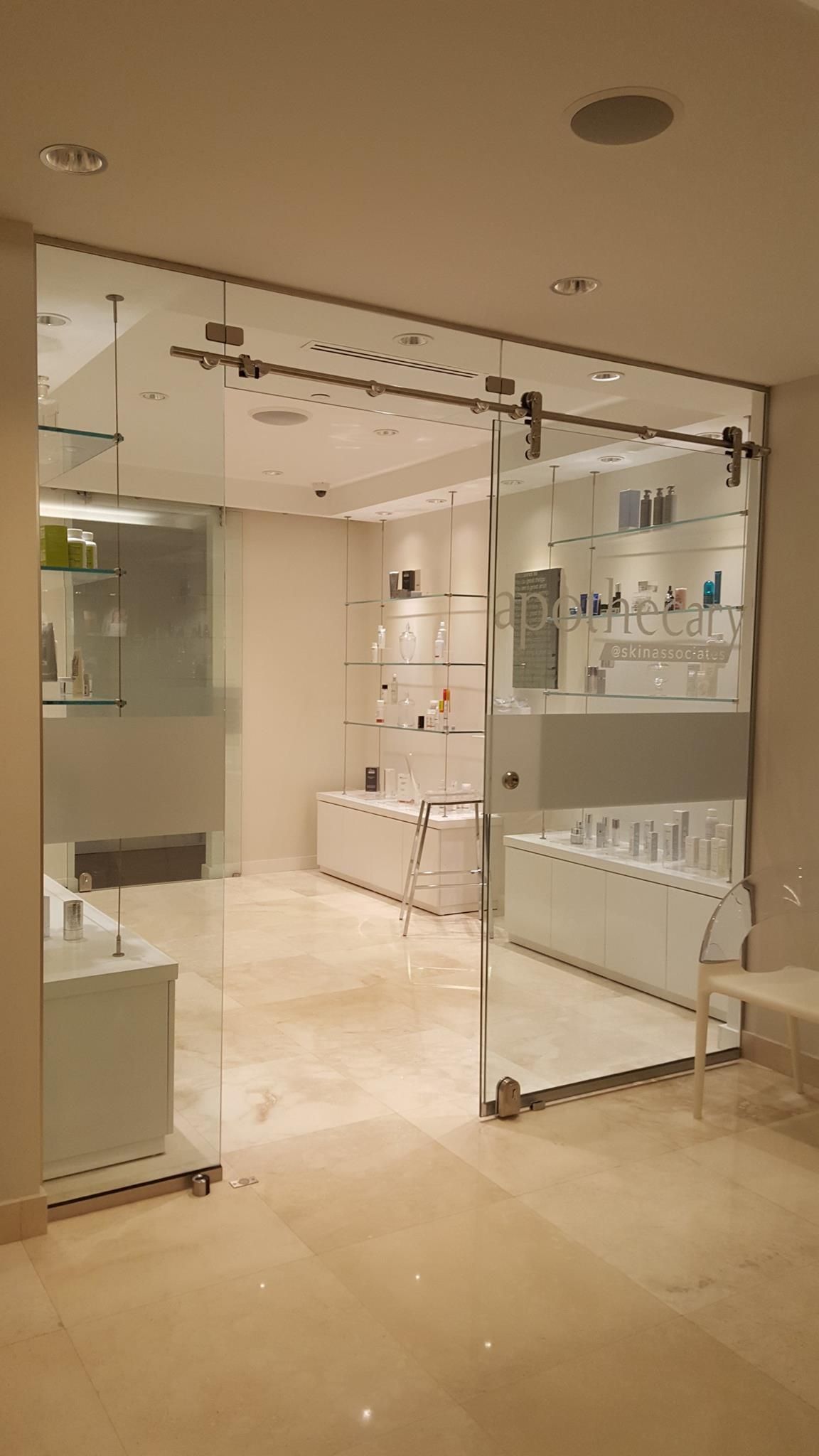 A room with a sliding glass door leading to a store.