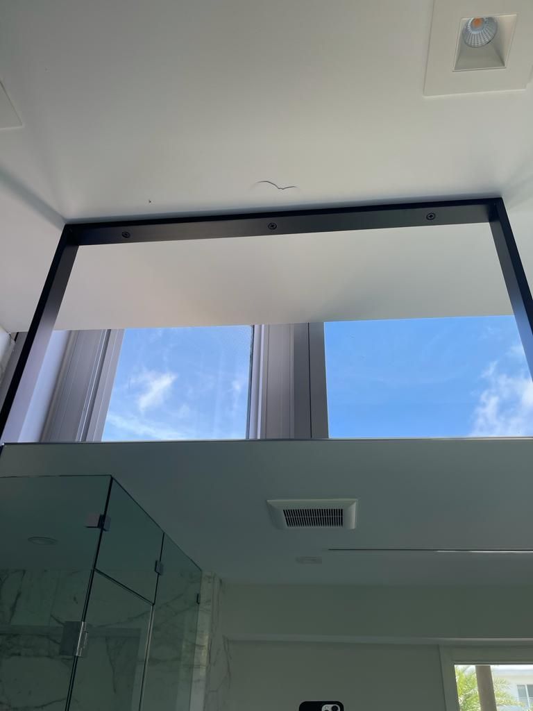A picture of a window with a blue sky behind it.
