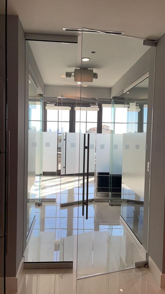 A hallway with a glass door and a lot of windows.