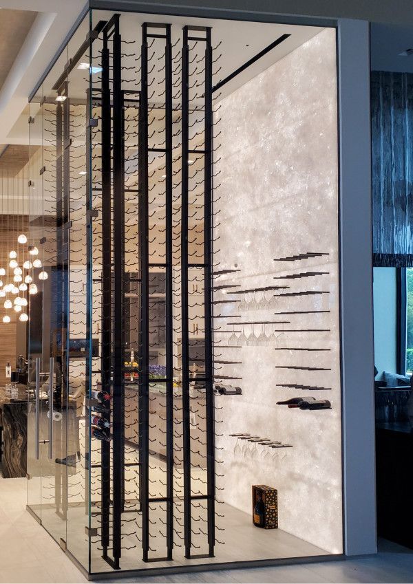 A glass wall with a wine rack behind it