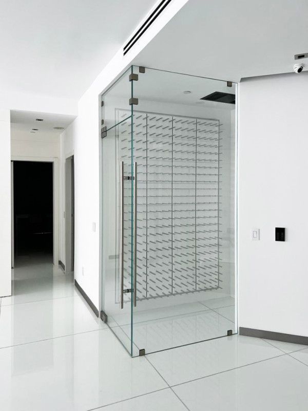 An empty room with a glass door and a wall of boxes