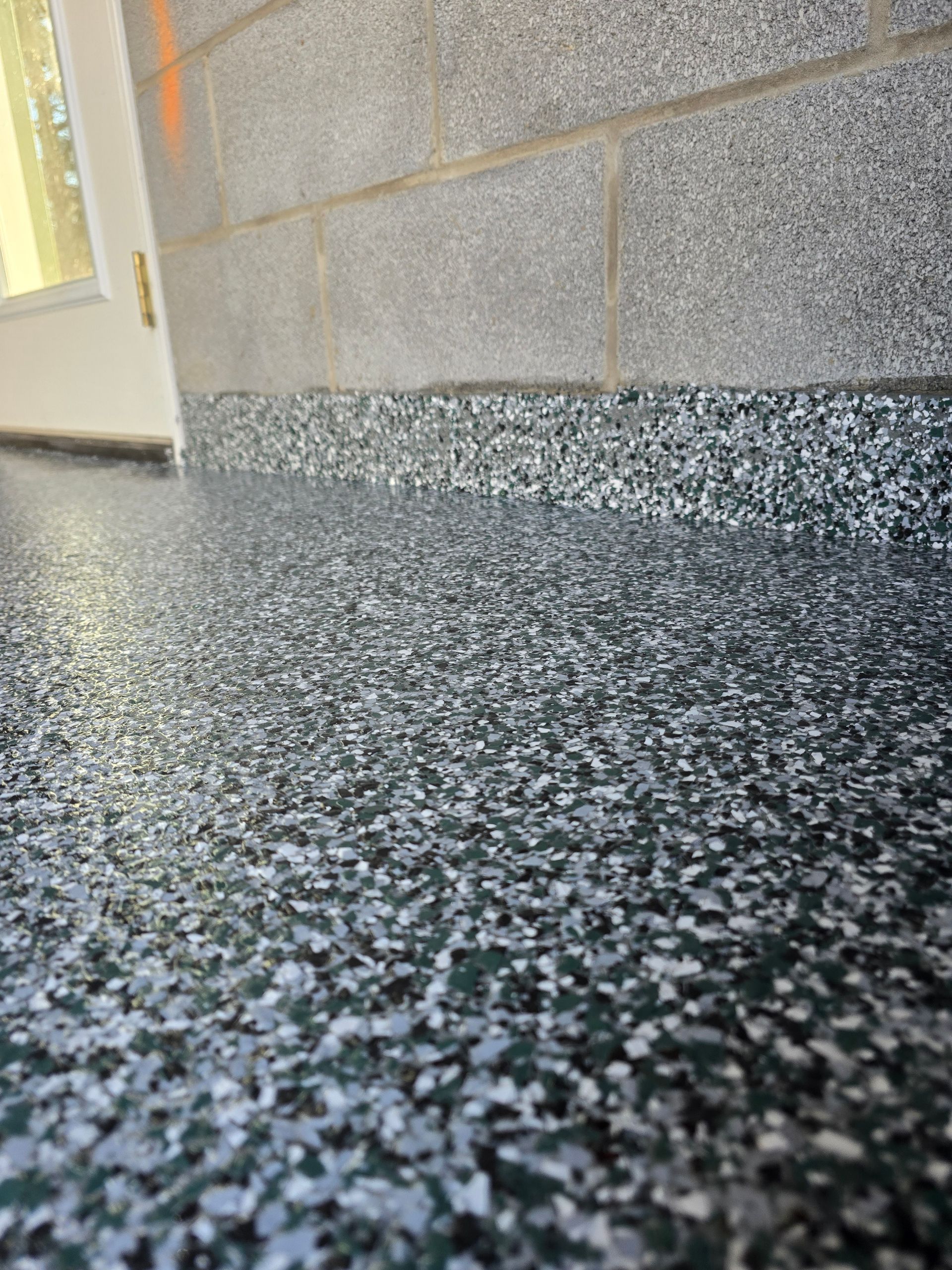 A close up of a concrete floor next to a brick wall.
