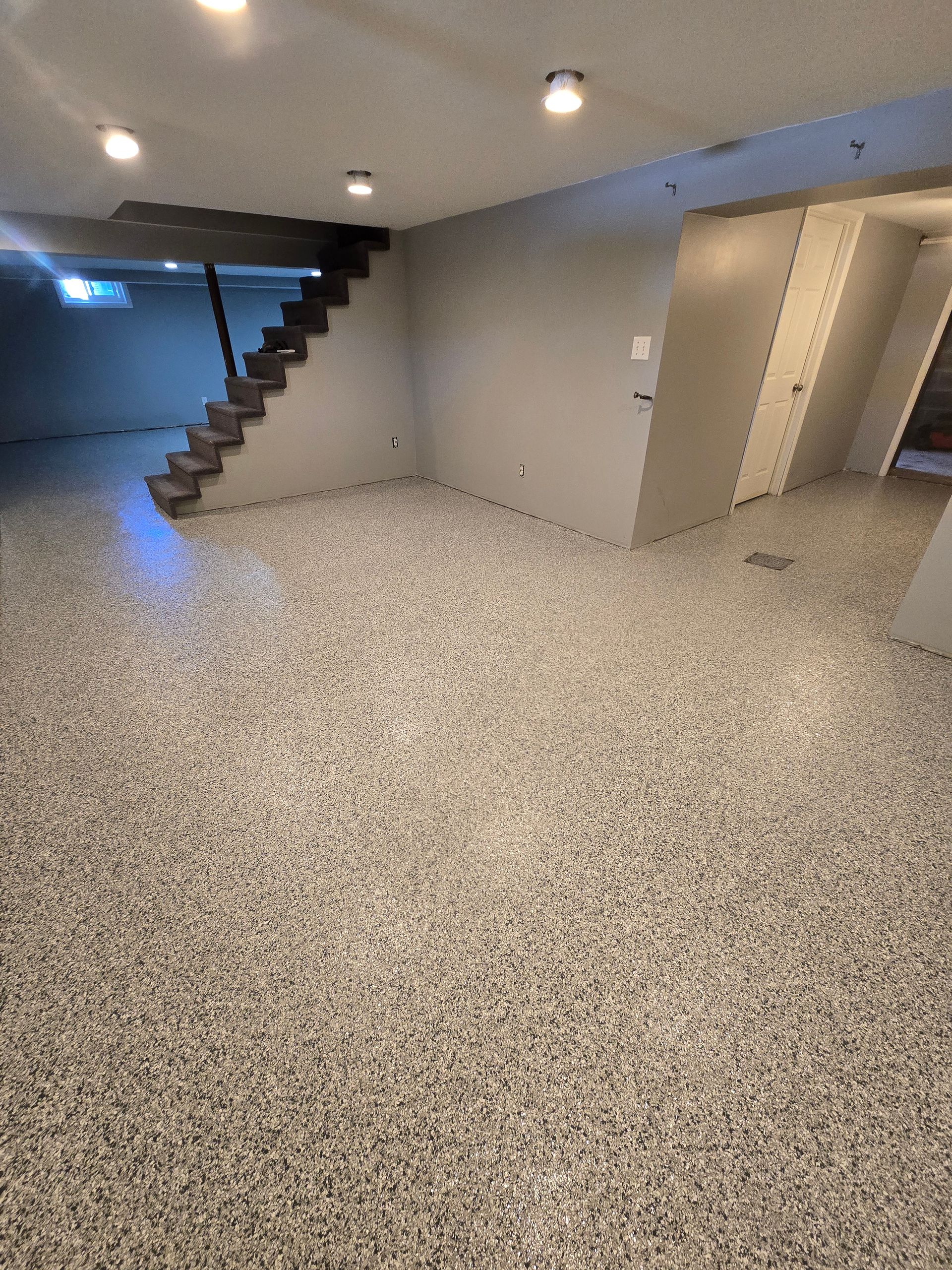 A basement with a staircase leading up to the second floor.