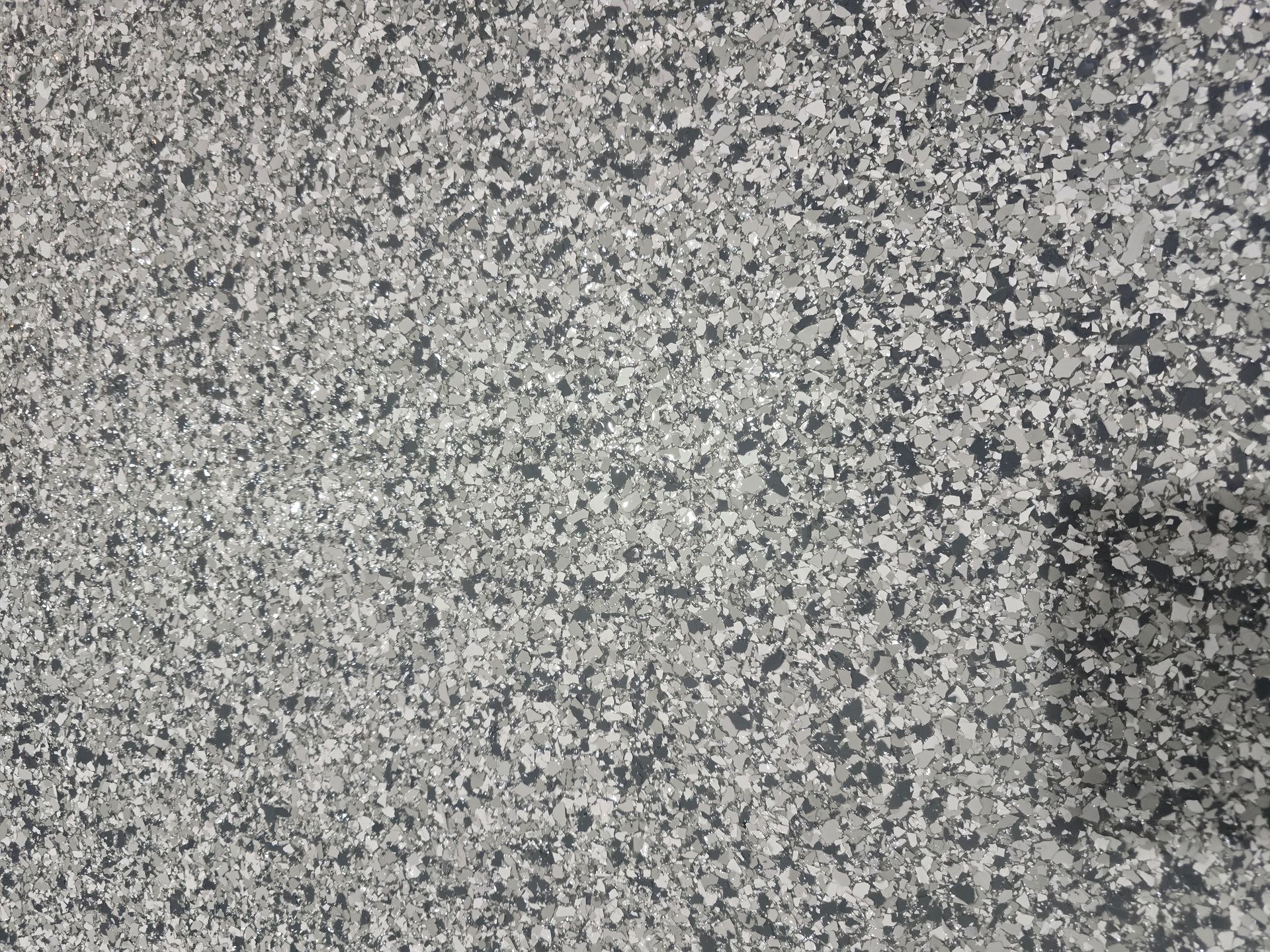A close up of a gray and black carpet texture.