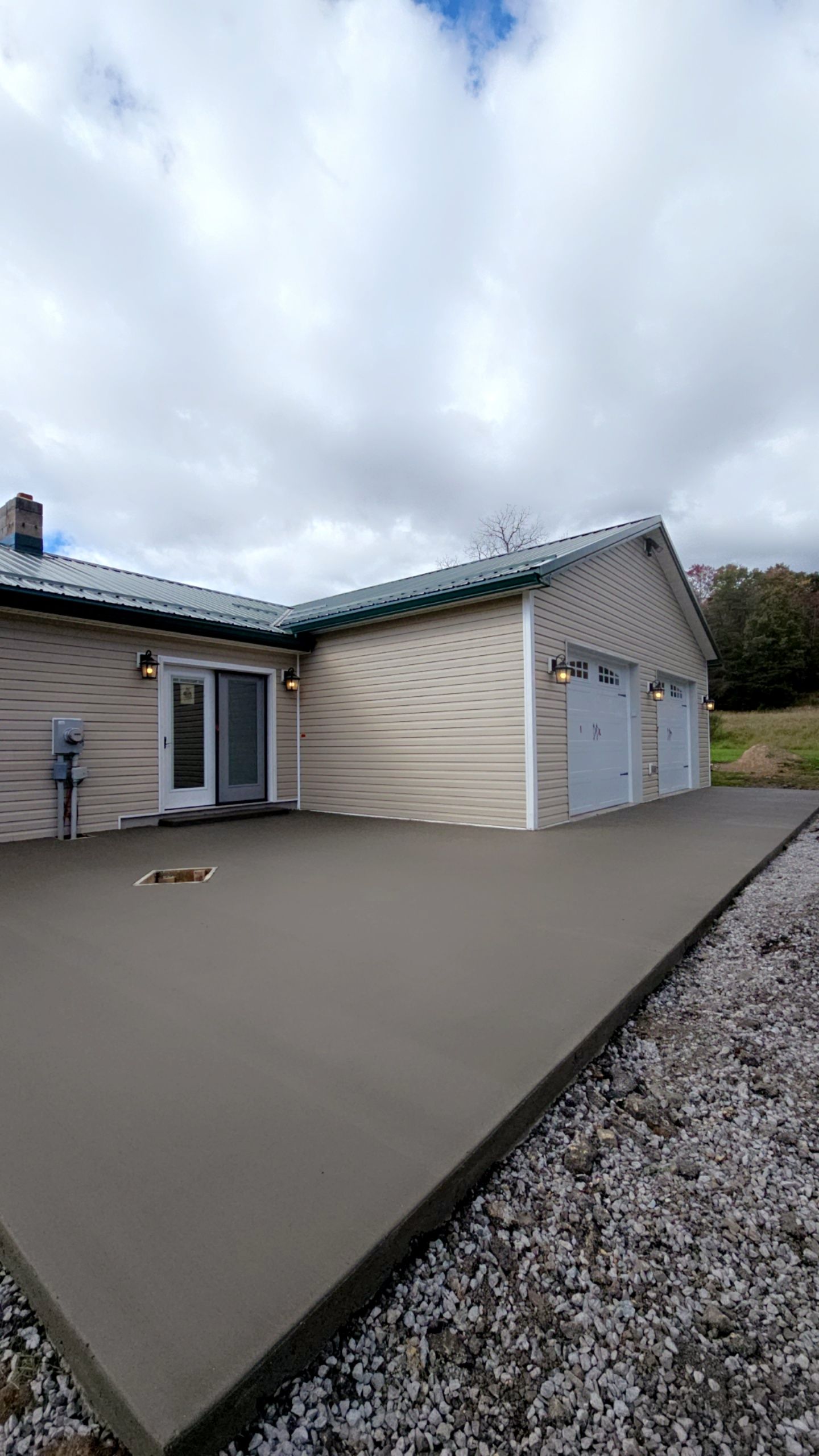 A house with a concrete patio in front of it.