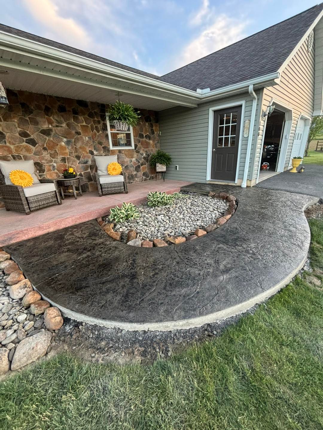 A house with a patio and a walkway in front of it.